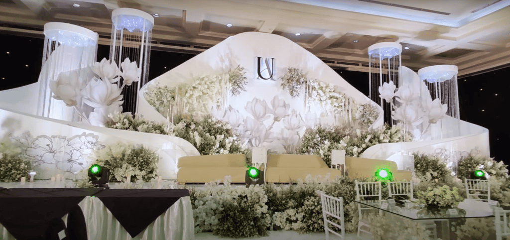 Curved wedding stage with flowers and crystal décor