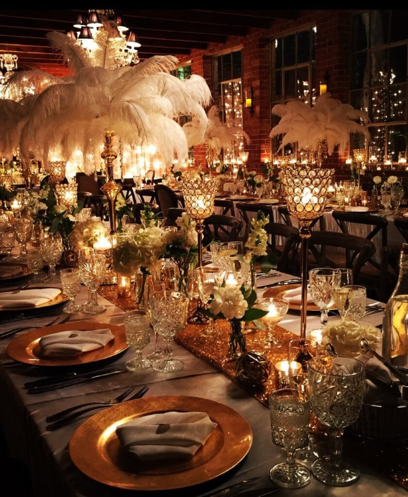Gatsby-style wedding decor with feathers and gold glow