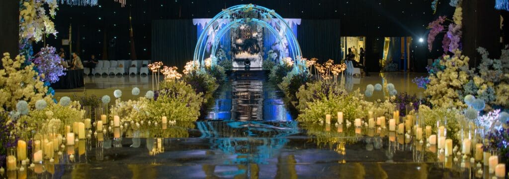 Magical aisle with glowing arches, hanging crystals, and candle-lined path
