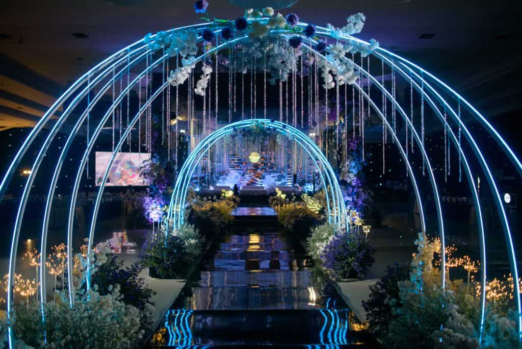 Mystical wedding aisle with light arches and floral design by Trinity Artwork