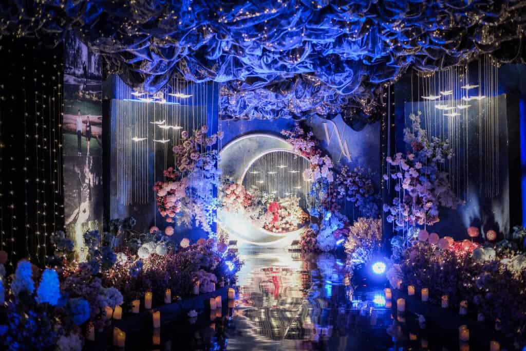 Mystical wedding stage with moon arch and hanging lights by Trinity Artwork