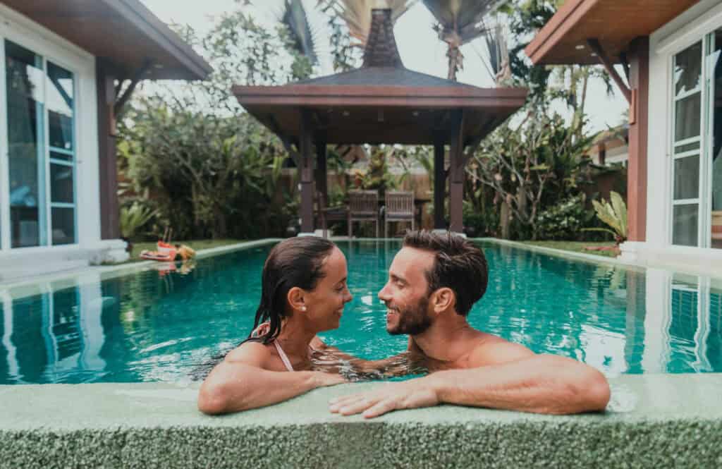 Couple enjoying a romantic villa stay with private pool